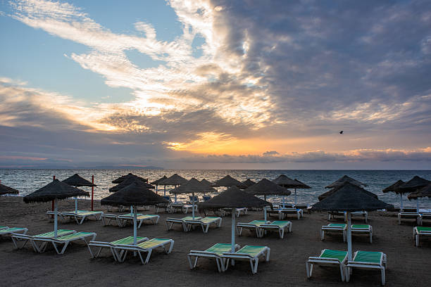 Sunrise landscape on the beach with beds, Spain
