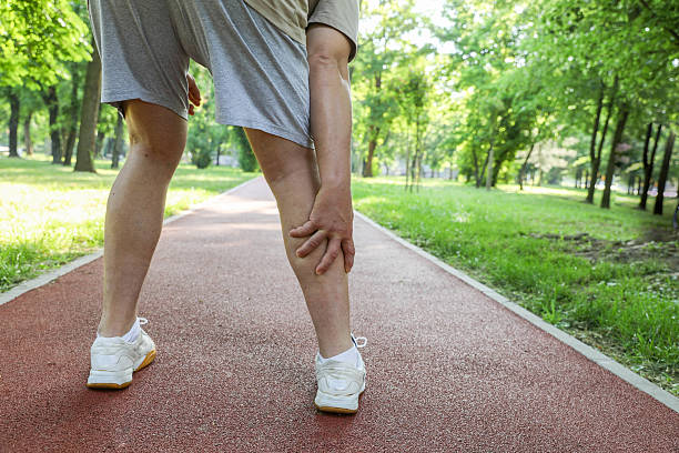 istock Sports Injury Concept With Man Holding Knee While Jogging 2224141134