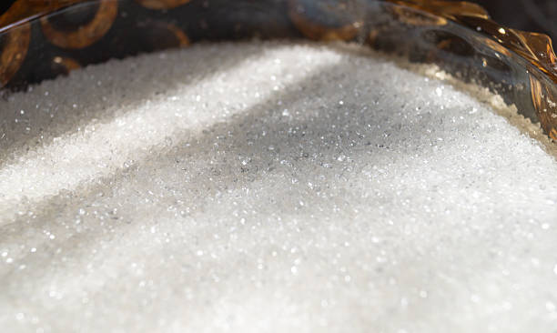 istock White sugar in a yellow glass vessel under sunlight closeup 2224142382