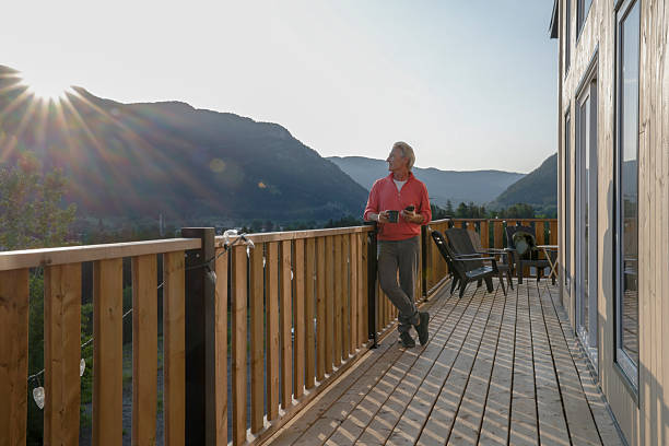 istock View down cabin deck to mature man watching sunrise 2224143591