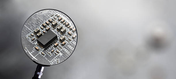 istock Close up of electronic circuit computer microchips focused by a magnifying glass 2224144133