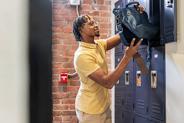 Professional young man retrieves his belongings from a locker at work