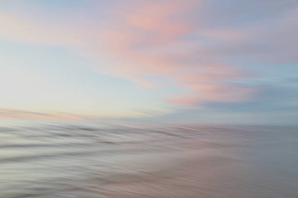 istock A dreamy, impressionistic paint like blurred sea sunset background with gently soft pastel colours. 2224146043