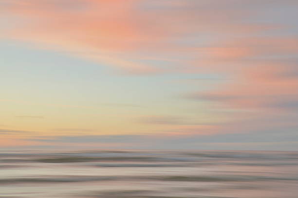 istock A dreamy, impressionistic paint like blurred sea sunset background with gently soft pastel colours. 2224146119