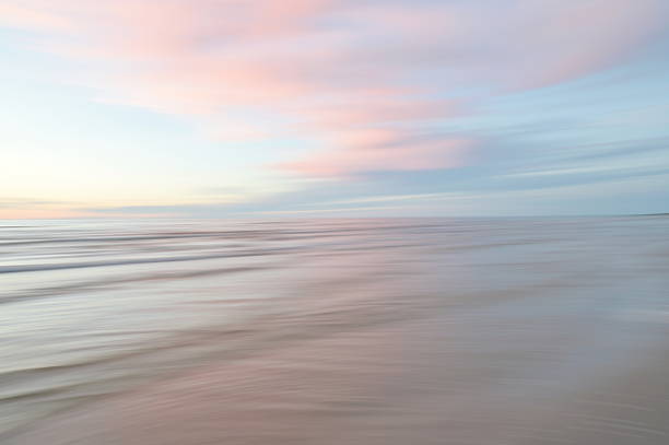 istock A dreamy, impressionistic paint like blurred sea sunset background with gently soft pastel colours. 2224146195