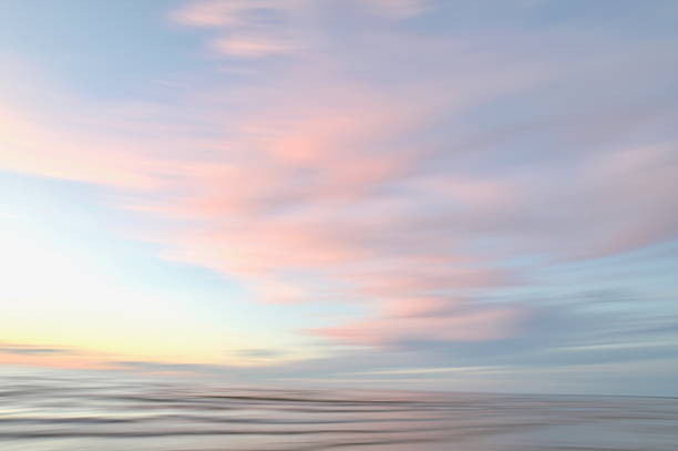 istock A dreamy, impressionistic paint like blurred sea sunset background with gently soft pastel colours. 2224146257