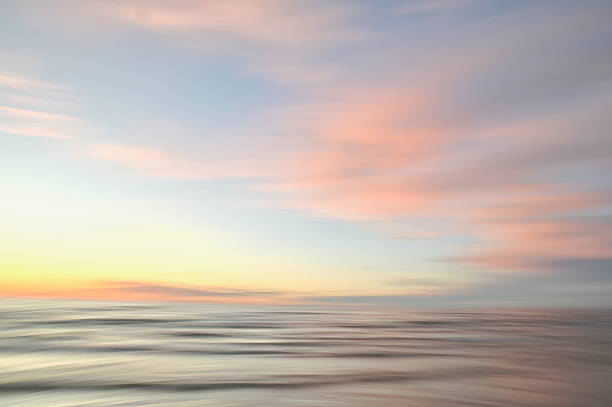 istock A dreamy, impressionistic paint like blurred sea sunset background with gently soft pastel colours. 2224146324