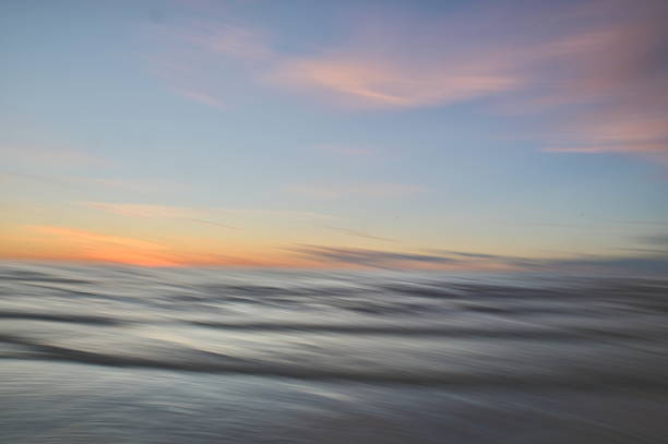 istock A dreamy, impressionistic paint like blurred sea sunset background with gently soft pastel colours. 2224146382
