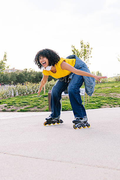istock Young woman roller skating and having fun in a park 2224147200