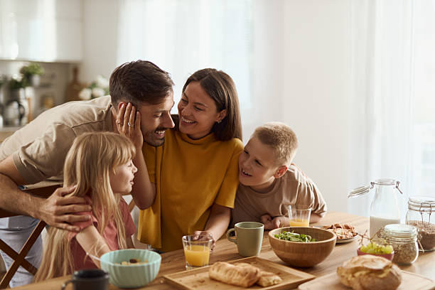 istock Young happy family talking during breakfast time at dining room 2224149062