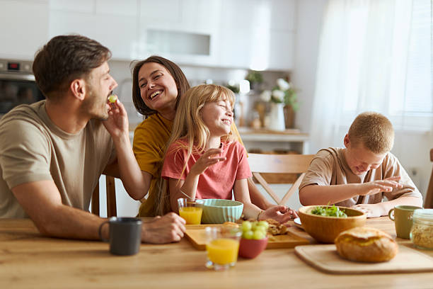 istock Happy family talking during breakfast at dining table. 2224149109