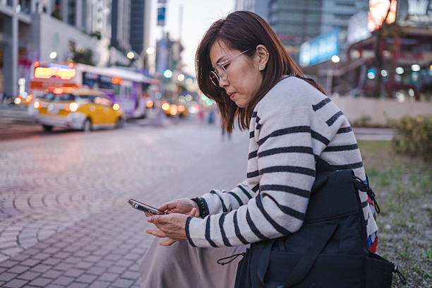 istock Twilight Connection: A Woman, a Smartphone, and a City 2224149865