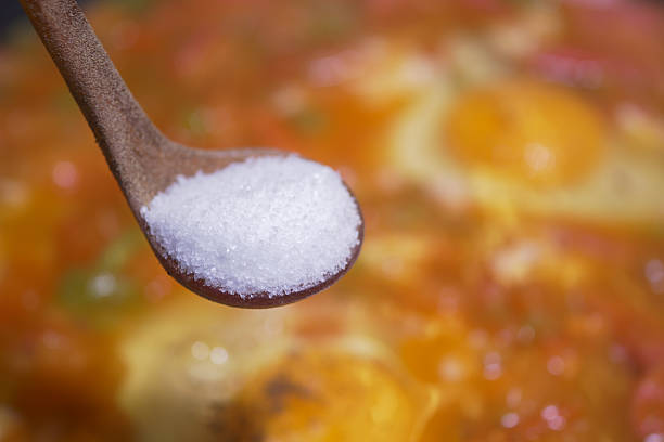 istock Cooking with salt added to a simmering dish in a kitchen 2224150205