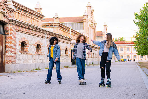 istock Young people having fun skating and showing direction in urban setting 2224151136