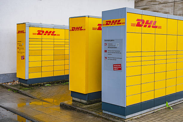 Dusseldorf, Germany - April 4 2024: Yellow DHL branded automated shipping stations in Flingern Nord area