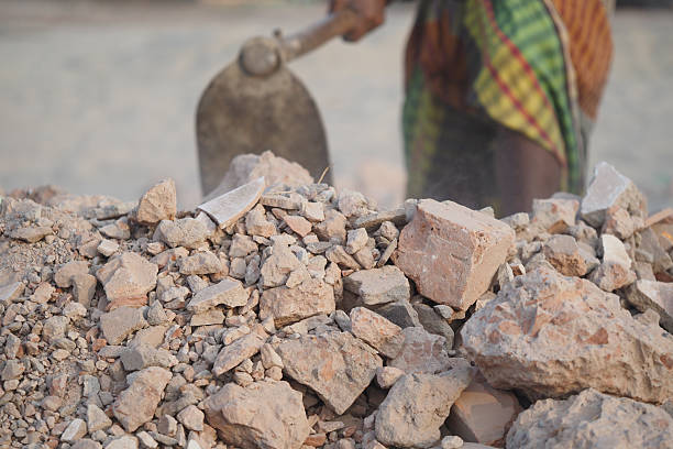 istock Construction worker digging in a gravel pile at a work site 2224154050