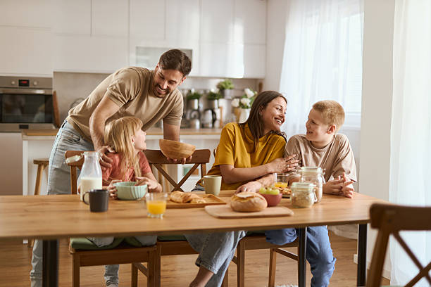 istock Young happy family talking during breakfast time at home 2224154777