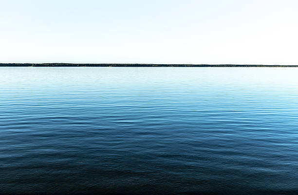 istock Calm lake with clear blue sky on the horizon 2224157418