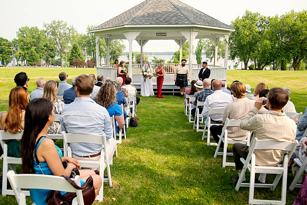 Millennial wedding ceremony outdoors in summer.
