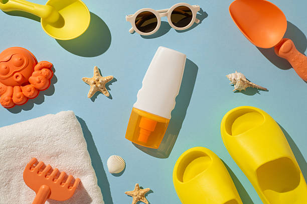 istock Various summer items arranged on a pastel background, including sunscreen, sunglasses, and beach toys 2224158437