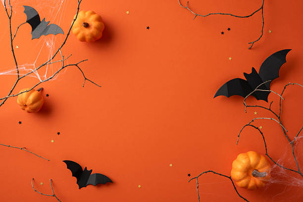 istock Halloween festive background design featuring bats, pumpkins, spider webs, and decorative twigs 2224158503