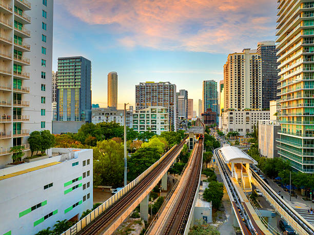 istock Elevated train system through Brickell district in Miami, Florida with city skyscrapers and sunset skies highlighting the public transportation network 2224159731