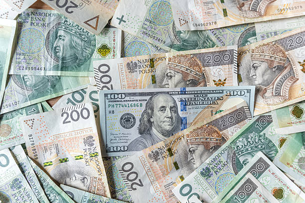 istock 100 US dollars banknotes banknote surrounded by polish zloty for exchange 2224159856