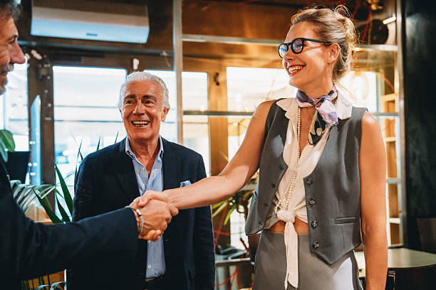 istock Businesspeople shaking hands during a meeting in a restaurant 2224163990