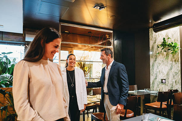 istock Restaurant manager welcoming customers at the entrance 2224164012