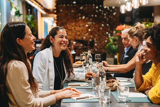 istock Friends laughing and enjoying dinner together at a restaurant 2224164670