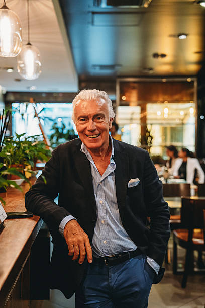istock Elegant senior businessman smiling in a restaurant 2224165249