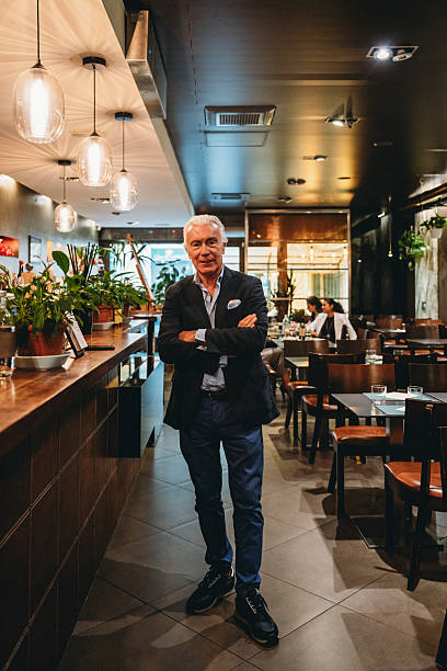 istock Senior restaurant manager posing in his restaurant 2224165293