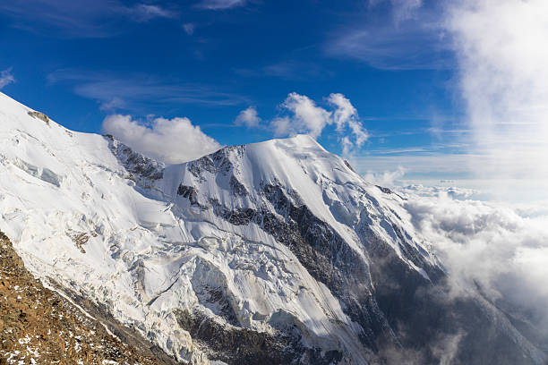 Highly detailed panoramic view from the Aiguille du Midi above Chamonix, France, over the snow capped domes of Mont Blanc, Europe's highest mountain, across the valley and picturesque Aiguille Rouges below towards the rocky escaparments and precipitous ridges of the Jura Alps. ProPhoto RGB profile for maximum color fidelity and gamut.