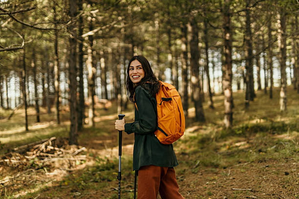 istock Happy hiker walking through forest during trekking excursion 2224174794