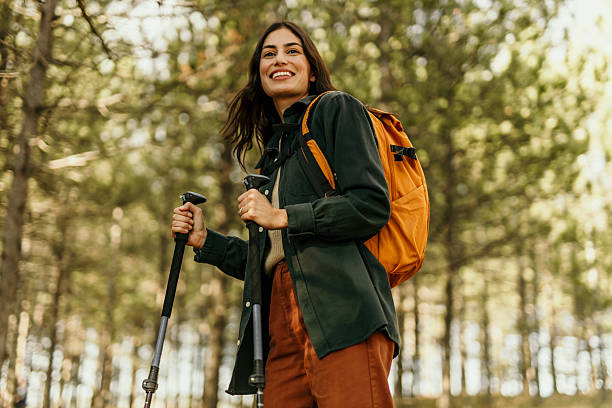 istock Young female hiker smiling while hiking in a forest 2224174797