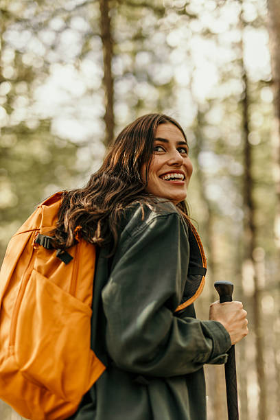 istock Young hiker smiling and hiking in a forest trail 2224174801