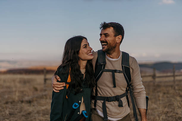 istock Happy hikers embracing and smiling during sunset hike 2224175093
