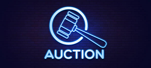 A blue neon sign featuring an auction gavel icon and the word \