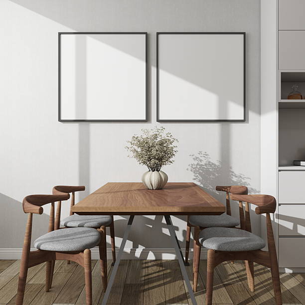 istock Modern dining room with two square frame mockups next to a decorative sideboard and table 2224178320