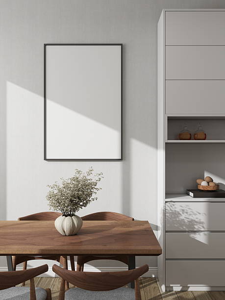 istock Modern dining room with a vertical frame mockup on a white wall next to a decorative sideboard and table 2224178335