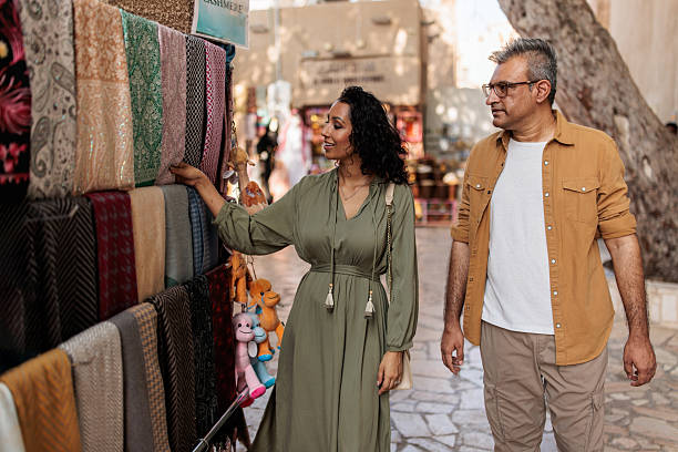 istock Middle Eastern Husband and Wife Selecting Headscarves in Dubai Souk 2224179298