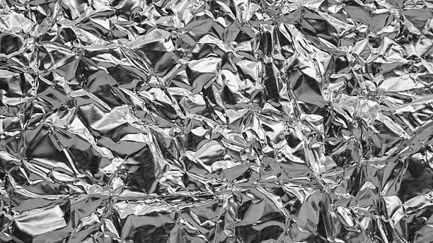 istock Shiny metal silver gray foil leaf crumpled texture background 2224179447
