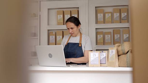 istock Eco-Friendly Coffee Shop. Focused Artisan At Work With Laptop 2224179484