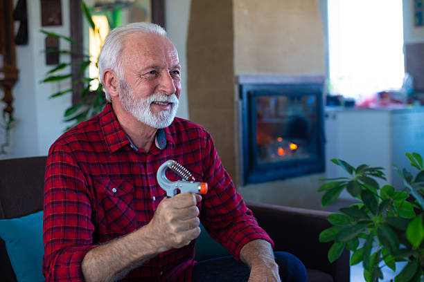 istock Senior man exercising and strengthening his hands using hand gripper 2224181495