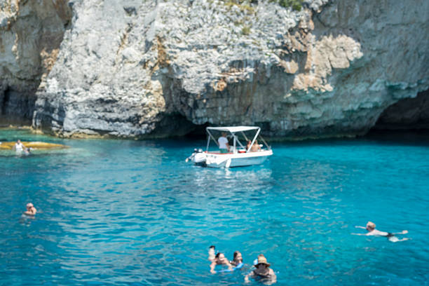 Antipaxos, Greece, 06/18/2025. Slightly blurred scene of tranquil turquoise waters and limestone cliffs