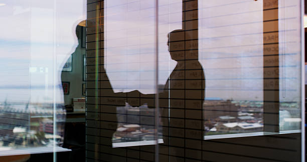 istock Window, reflection and handshake with business people in office for regional plan, urban developer and b2b. Partnership, zoning code regulation and property acquisition with employees shaking hands 2224182477