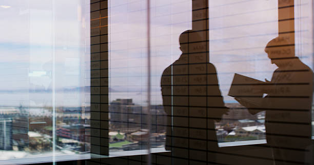 istock Silhouette, meeting and team with business people in office for regional plan, urban developer and b2b. Partnership, zoning code regulation and property acquisition with employees for infrastructure 2224182481