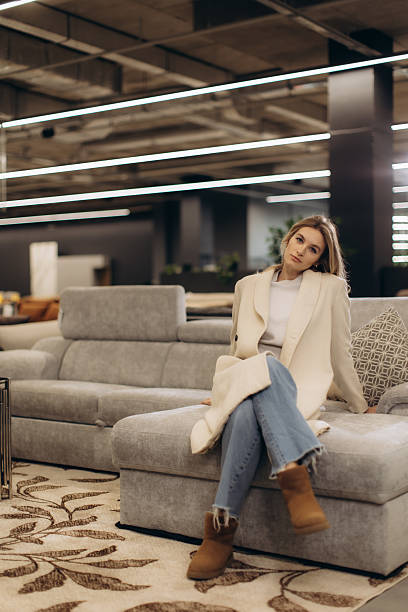 istock Young Woman Relaxing on a Comfortable Gray Sofa in a Modern Interior 2224182574