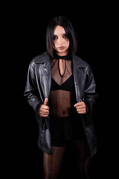 person posing in a studio environment with a dark background