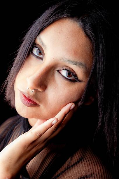 person posing in a studio environment with a dark background